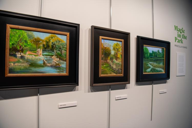 Three landscape paintings in dark frames
