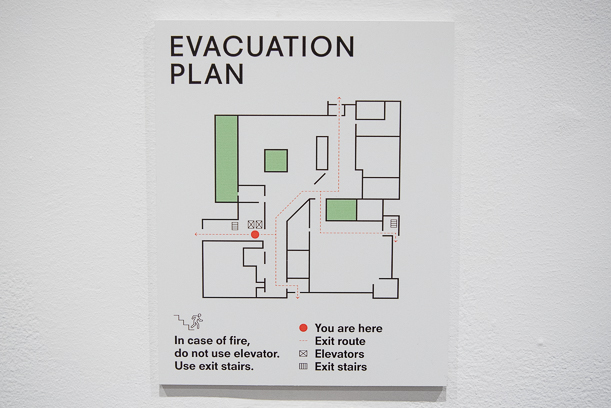 An evacuation plan sign marked with green and red.