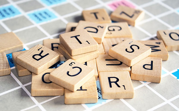 A pile of Scrabble letters on a Scrabble board.
