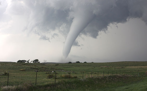 Large tornado touches down on rural farm area.