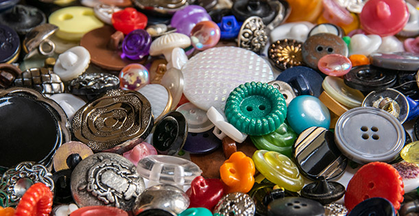 A messy pile of buttons or all colors, shapes, and types.