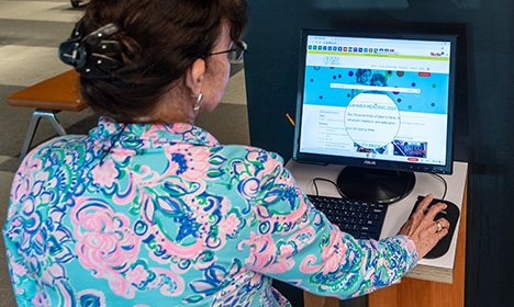 a woman using accessibility tools on the Skokie Public Library website