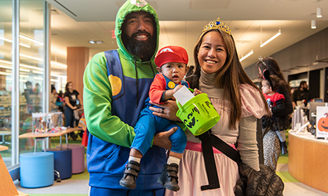 family wearing Mario family costume and holding a bag of candy