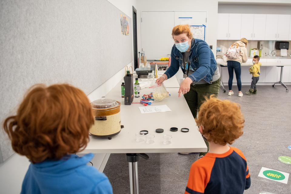 A staff person leads children through an activity in the Activity Room.