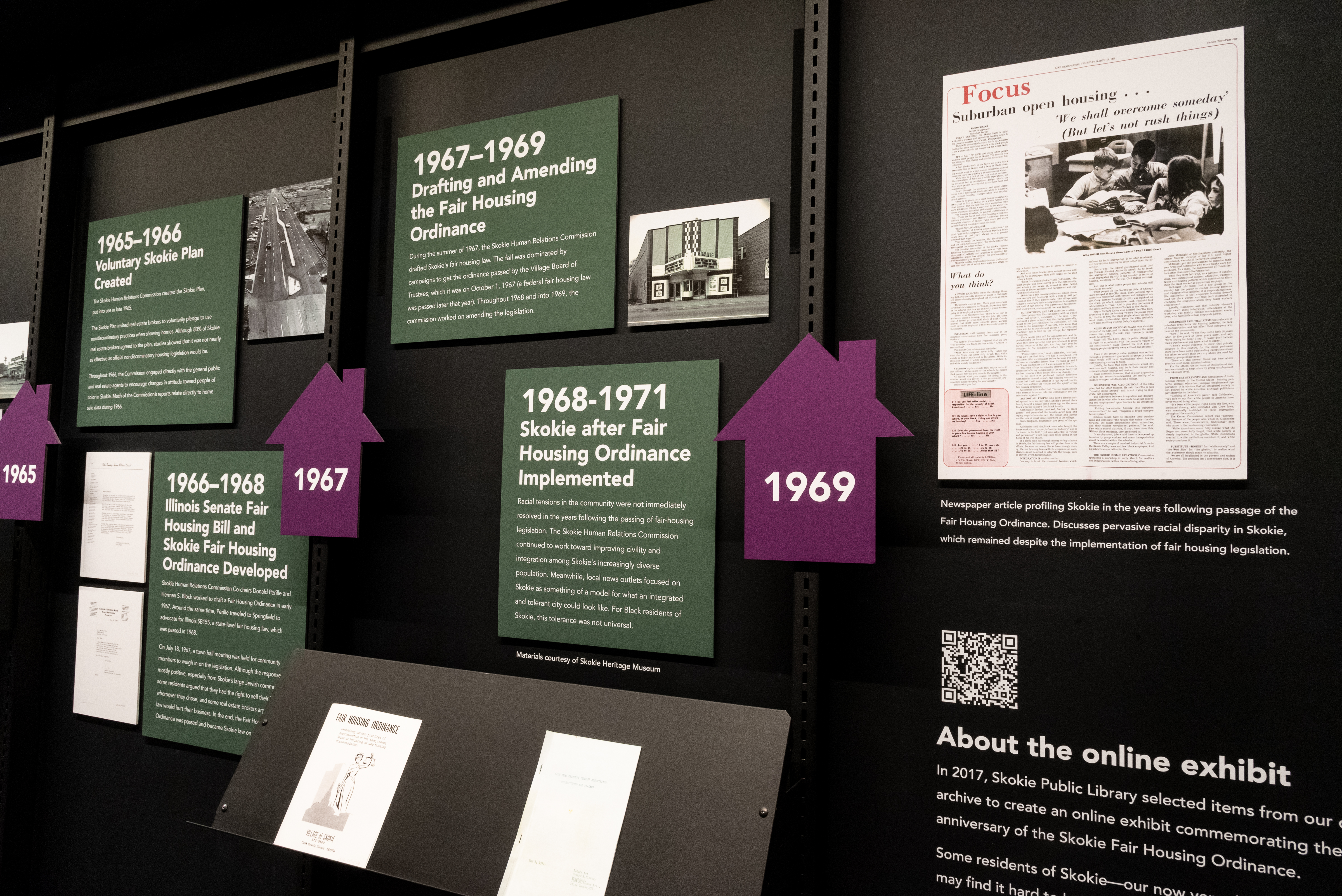 shot of a physical exhibit displaying fair housing in the 1960s. There are pamphlets and images from that time. 