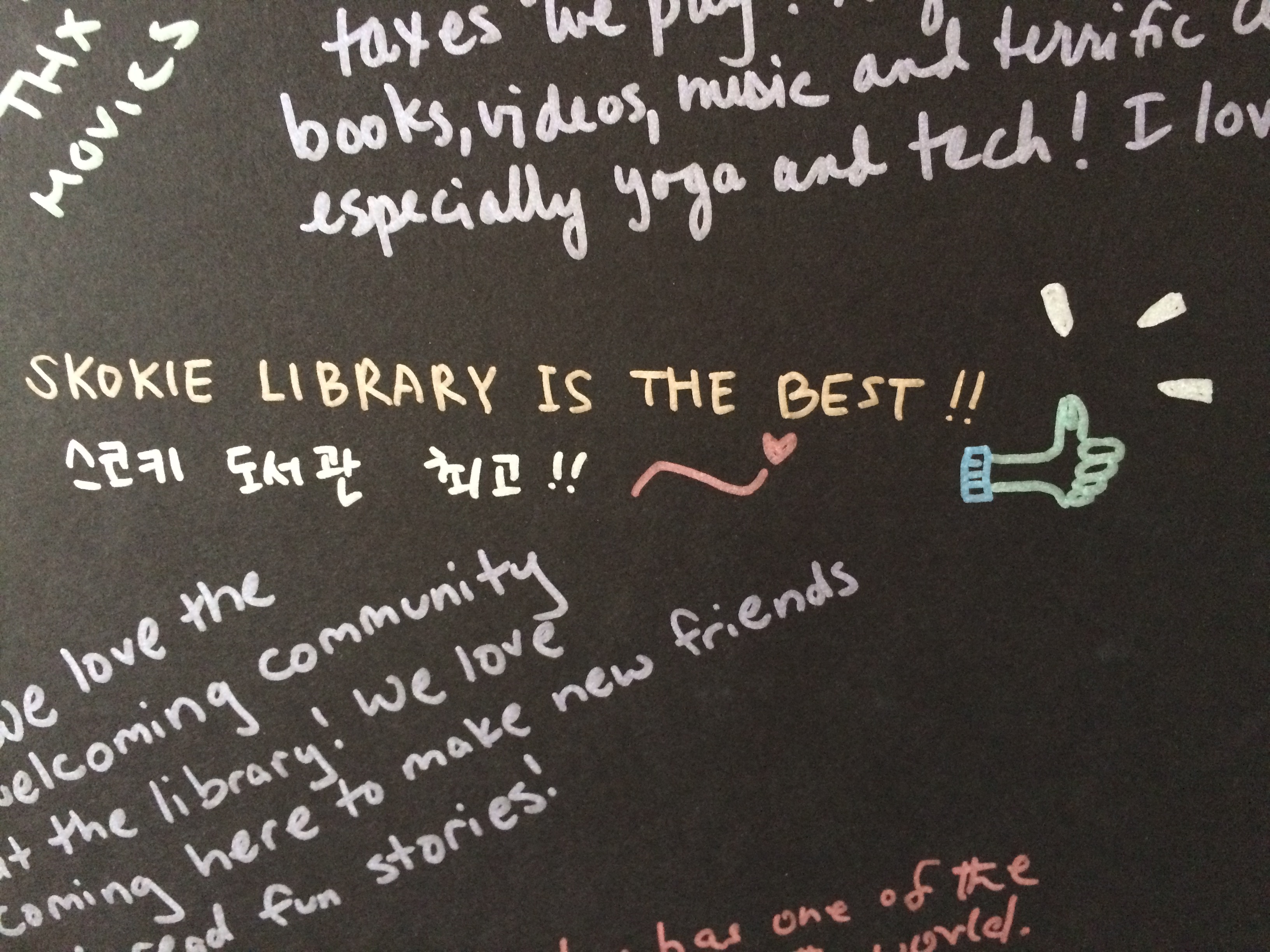 "SKOKIE LIBRARY IS THE BEST!" written on a graffiti board
