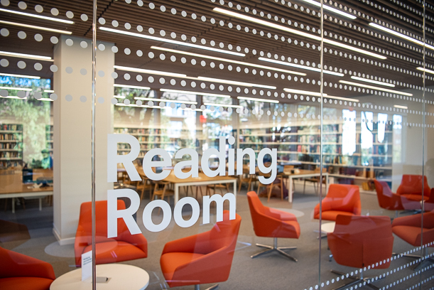 A photo of the glass outside the Reading Room reading "Reading Room" and showing lines of dots in a grid.