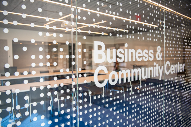 The glass outside the Business and Community Center, with random dots on a grid and the words "Business & Community Center".