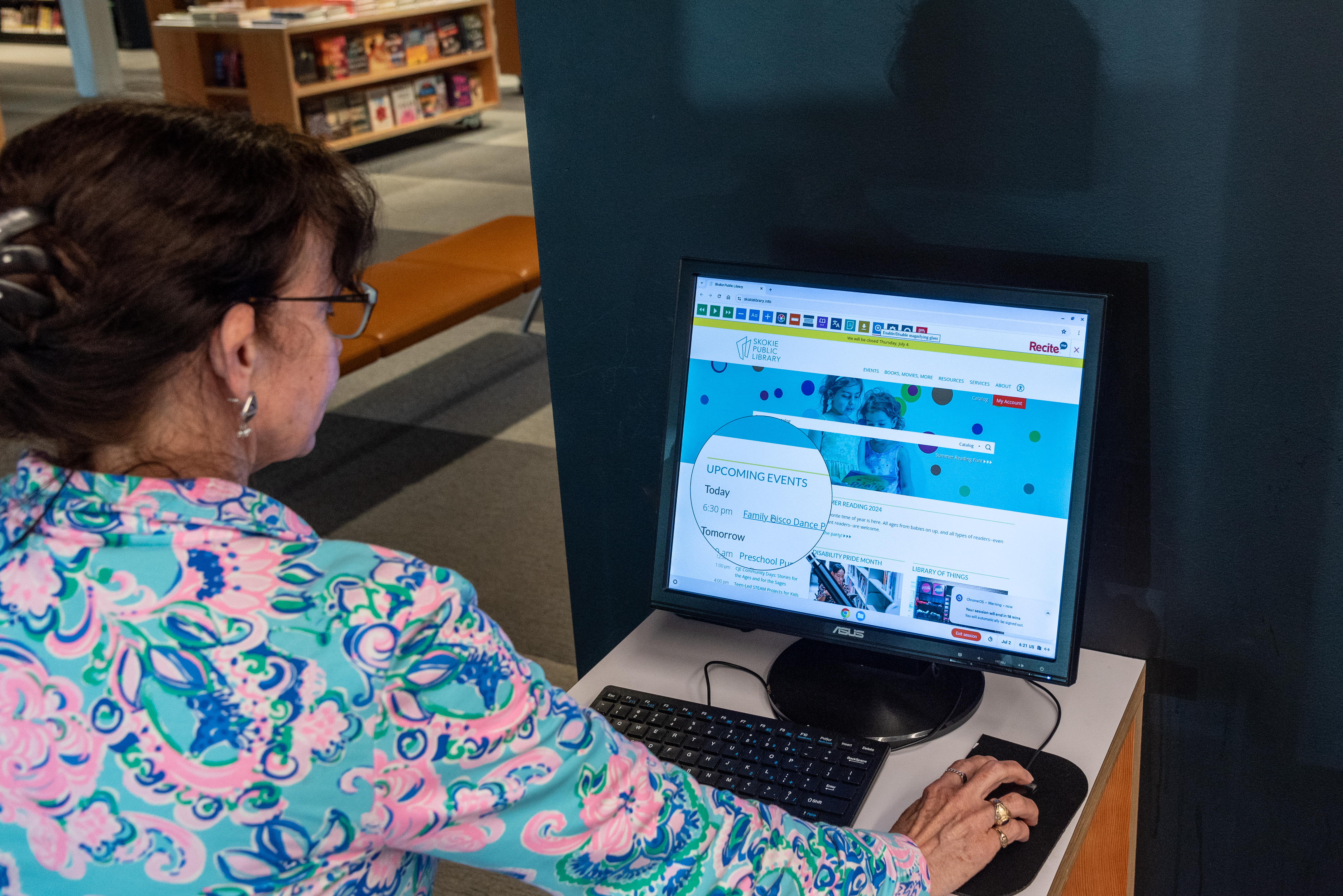 woman operating a computer. The magnifying glass tool is on the homepage of the screen woman operating a computer. The magnifying glass tool is on the homepage of the screen