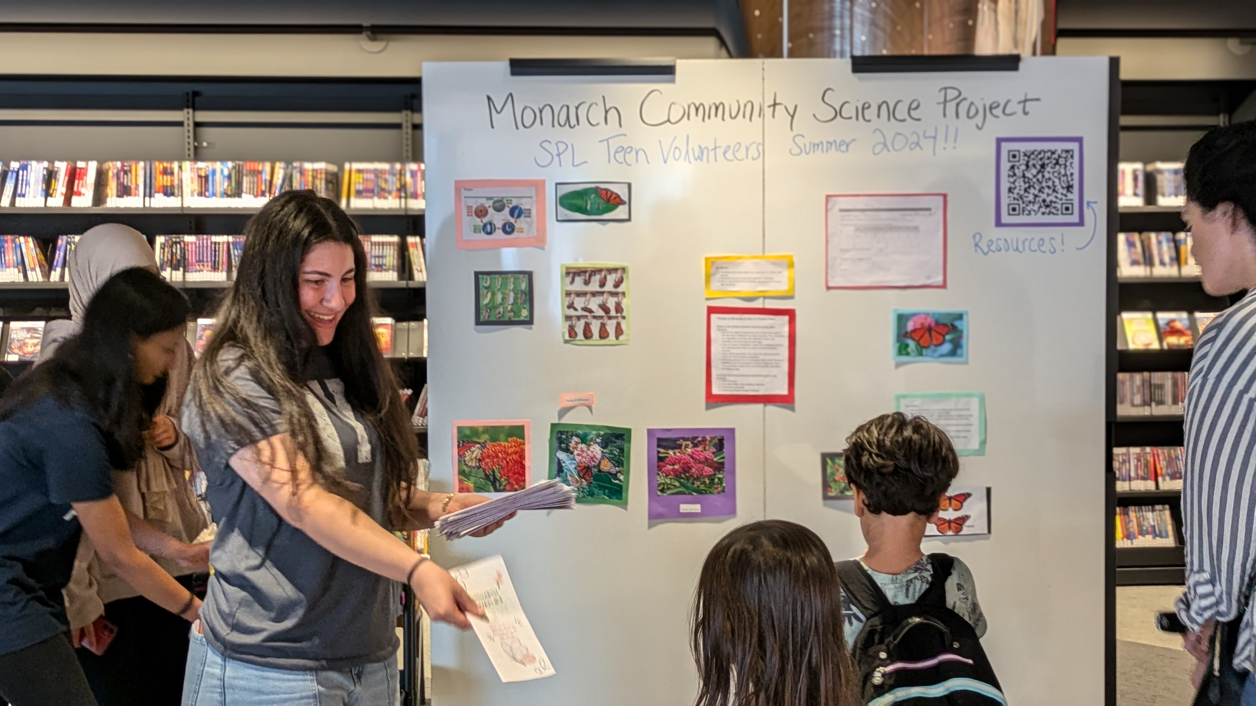 teens presenting to library patrons on monarch butterflies. 